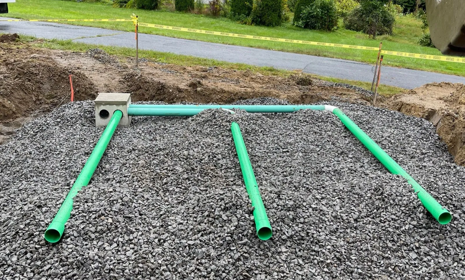 Drain field pipe laid on a stone bed